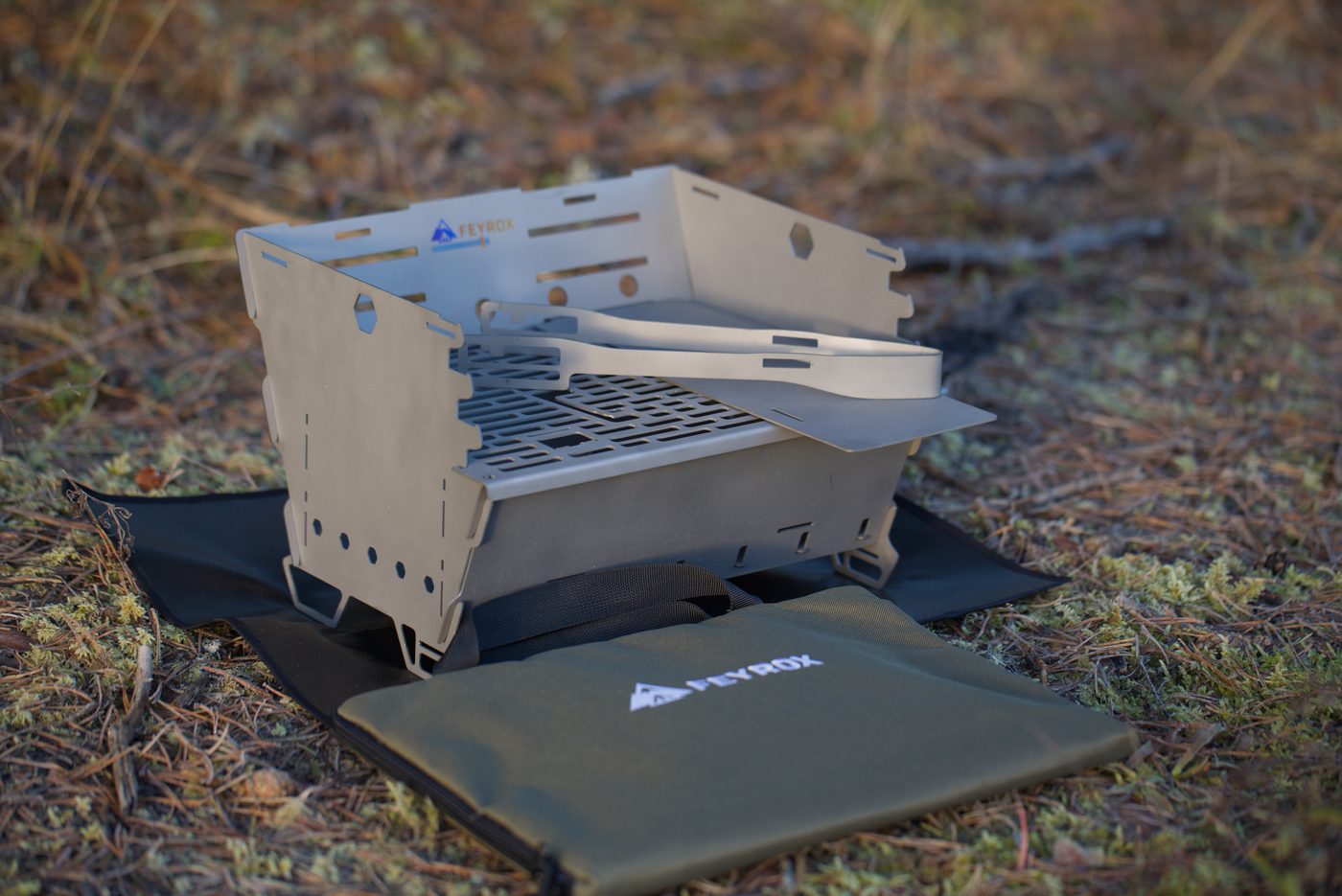 Titan1 folded down beside its carry bag, showing how flat the panels stack