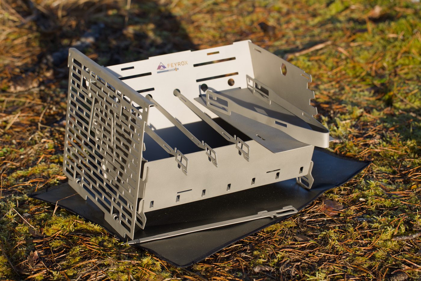 Titan1 titanium grill assembled with the grate on a base mat